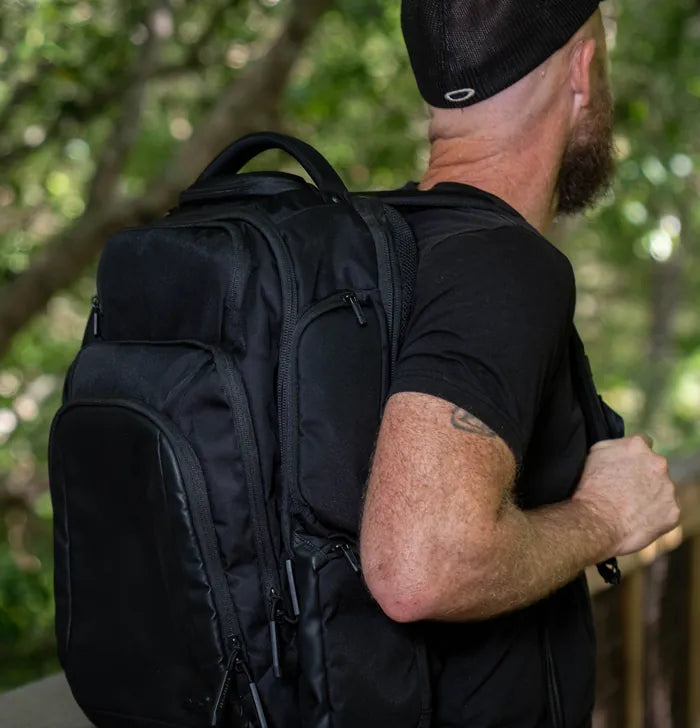 Man carrying the EscapeZone Dual backpack outdoors