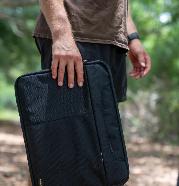 Man carrying the EscapeZone Faraday laptop bag outdoors